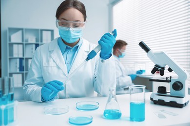 Photo of Medical analysis. Scientist working with sample in laboratory, selective focus