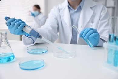Photo of Medical analysis. Scientist working with sample in laboratory, selective focus