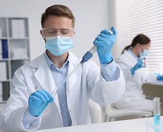 Photo of Medical analysis. Scientist working with sample in laboratory, selective focus
