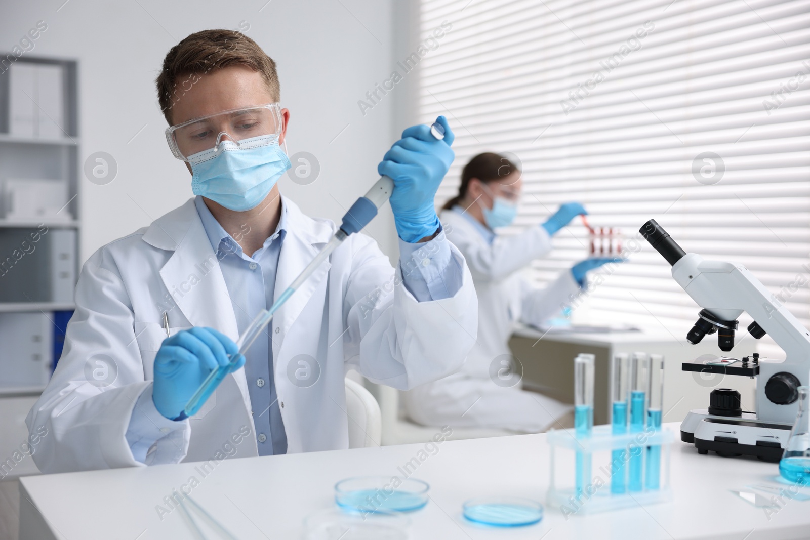 Medical analysis. Scientist working with sample in laboratory, selective focus Photo of Medical analysis. Scientist working with sample in laboratory, selective focus