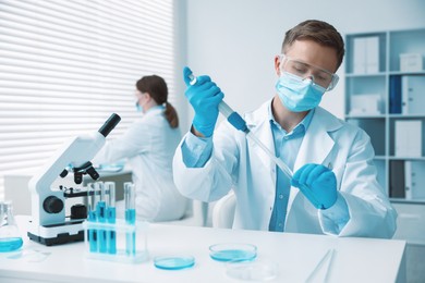 Photo of Medical analysis. Scientist working with sample in laboratory, selective focus