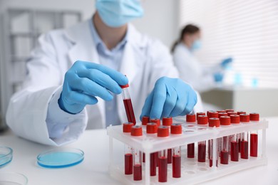 Photo of Medical analysis. Scientist working with blood sample in laboratory, selective focus