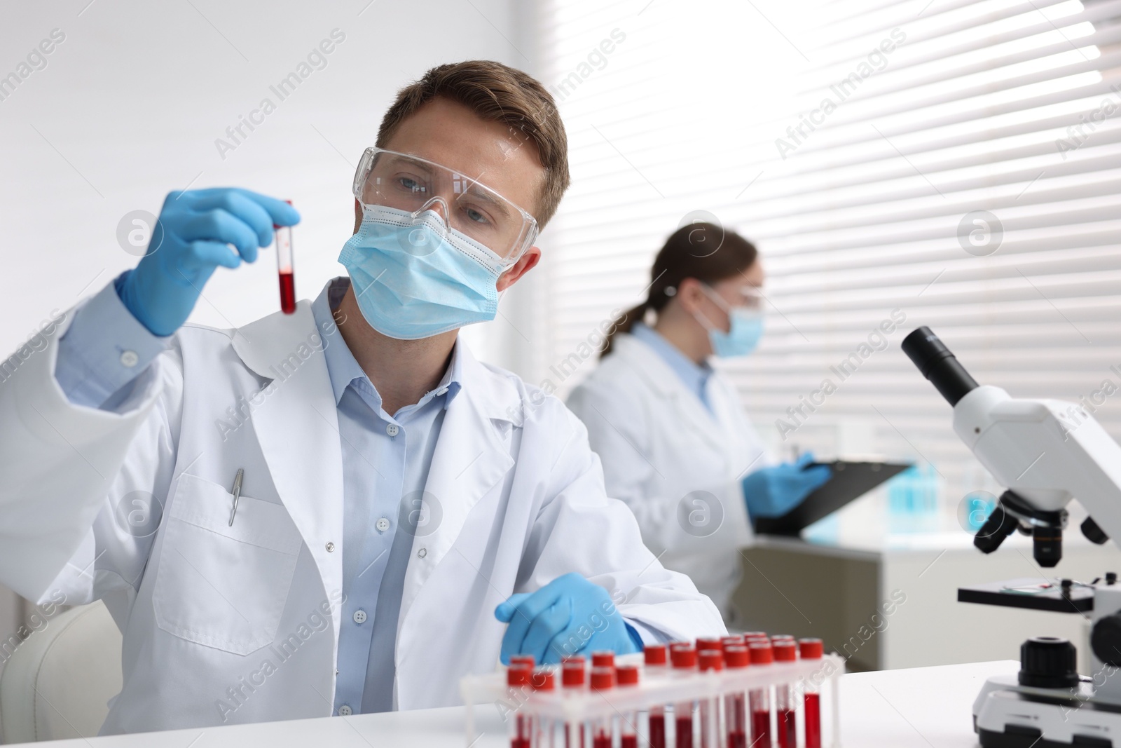 Medical analysis. Scientist working with blood sample in laboratory, selective focus Photo of Medical analysis. Scientist working with blood sample in laboratory, selective focus