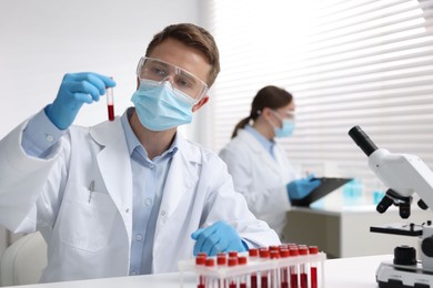 Photo of Medical analysis. Scientist working with blood sample in laboratory, selective focus