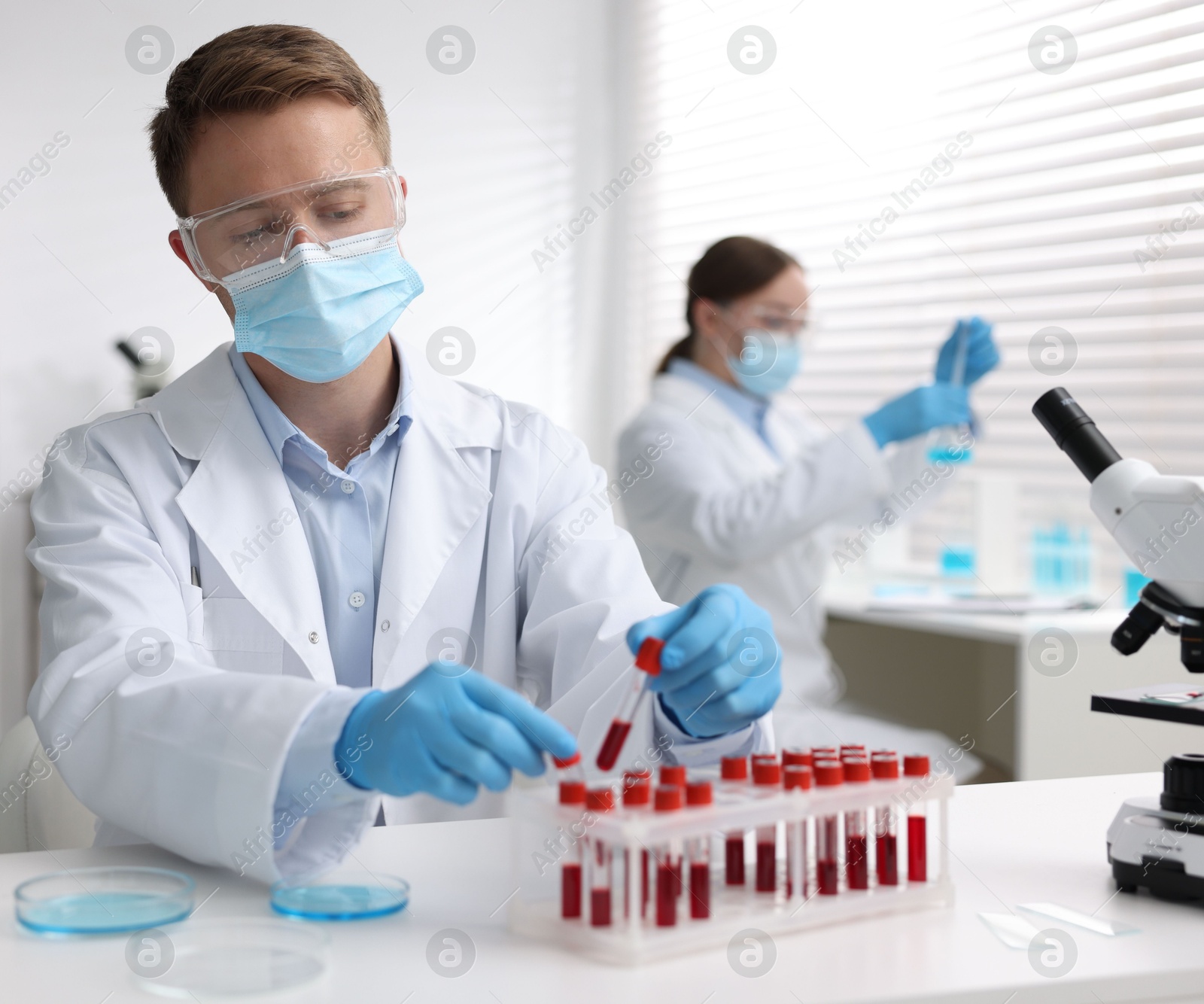 Medical analysis. Scientist working with blood sample in laboratory, selective focus Photo of Medical analysis. Scientist working with blood sample in laboratory, selective focus