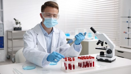 Photo of Medical analysis. Scientist working with sample in laboratory