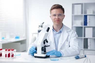 Photo of Medical analysis. Scientist working with microscope in laboratory