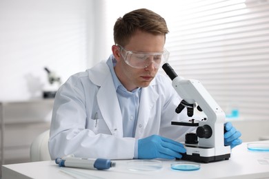 Photo of Medical analysis. Scientist working with microscope in laboratory