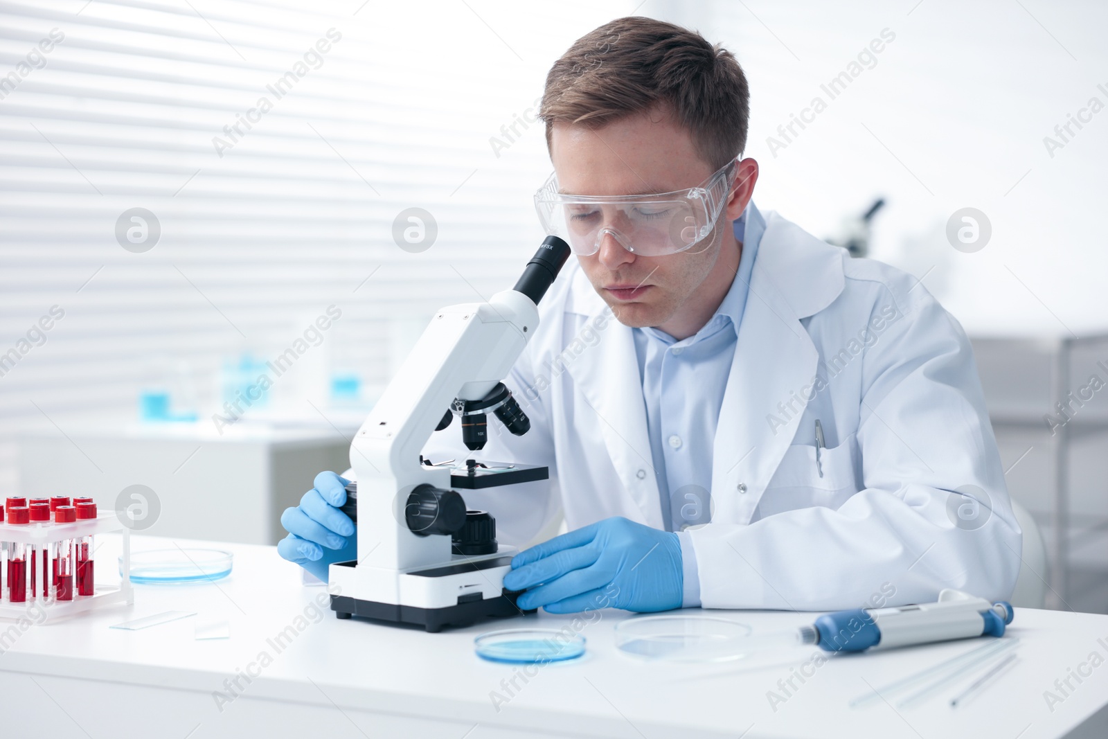 Medical analysis. Scientist working with microscope in laboratory Photo of Medical analysis. Scientist working with microscope in laboratory