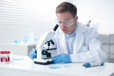 Photo of Medical analysis. Scientist working with microscope in laboratory