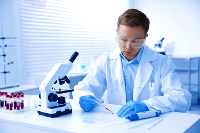 Photo of Medical analysis. Scientist working with blood sample in laboratory