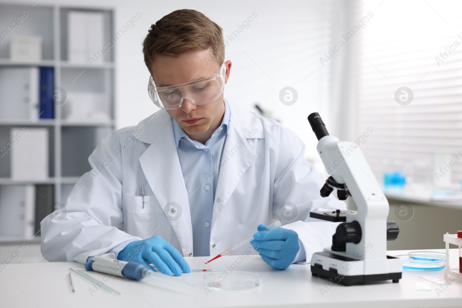Medical analysis. Scientist working with blood sample in laboratory Photo of Medical analysis. Scientist working with blood sample in laboratory