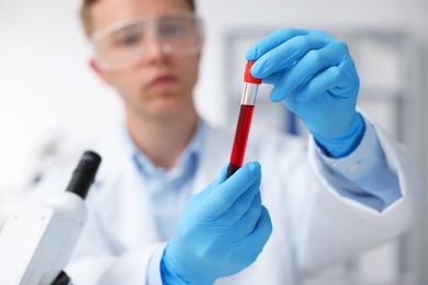 Photo of Medical analysis. Scientist working with blood sample in laboratory, selective focus
