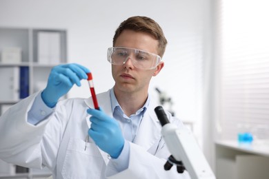 Photo of Medical analysis. Scientist working with blood sample in laboratory