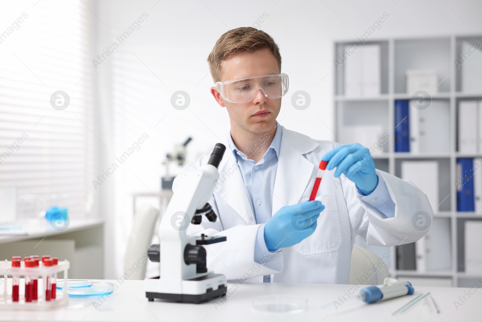 Medical analysis. Scientist working with blood sample in laboratory Photo of Medical analysis. Scientist working with blood sample in laboratory