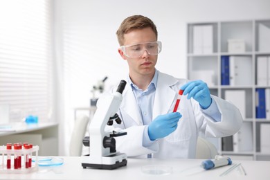 Photo of Medical analysis. Scientist working with blood sample in laboratory