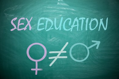 Image of Sex Education inscription, female and male gender signs on green chalkboard