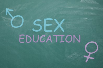 Image of Sex Education inscription, female and male gender signs on green chalkboard
