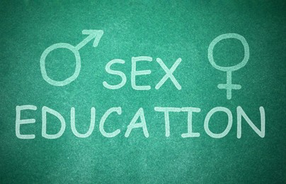 Image of Sex Education inscription, female and male gender signs on green chalkboard
