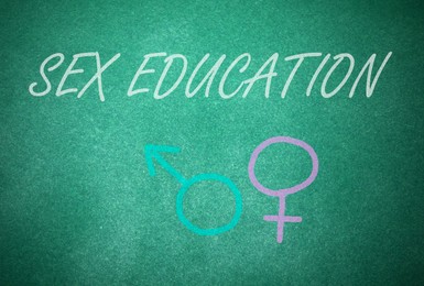 Image of Sex Education inscription, female and male gender signs on green chalkboard