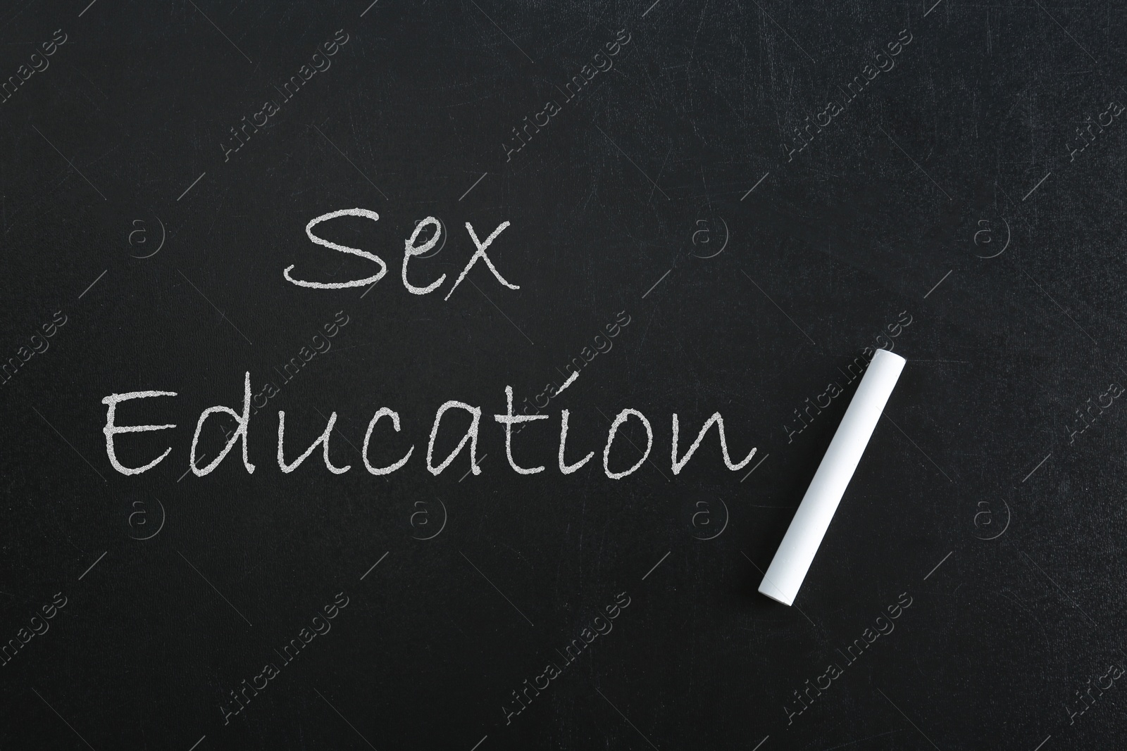 Sex Education inscription and piece of chalk on black chalkboard Image of Sex Education inscription and piece of chalk on black chalkboard