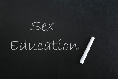 Image of Sex Education inscription and piece of chalk on black chalkboard