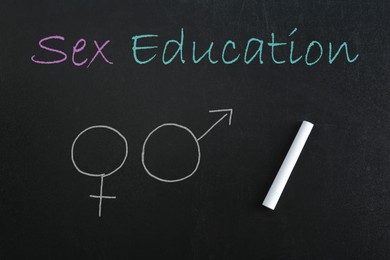 Image of Sex Education inscription, female and male gender signs on black chalkboard