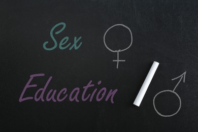 Image of Sex Education inscription, female and male gender signs on black chalkboard