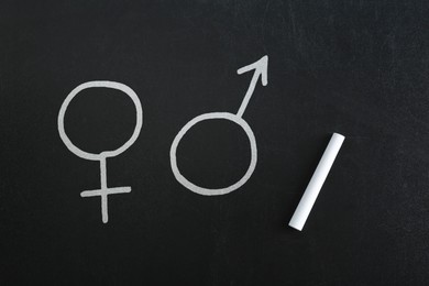 Image of Sex education. Female and male gender signs on black chalkboard