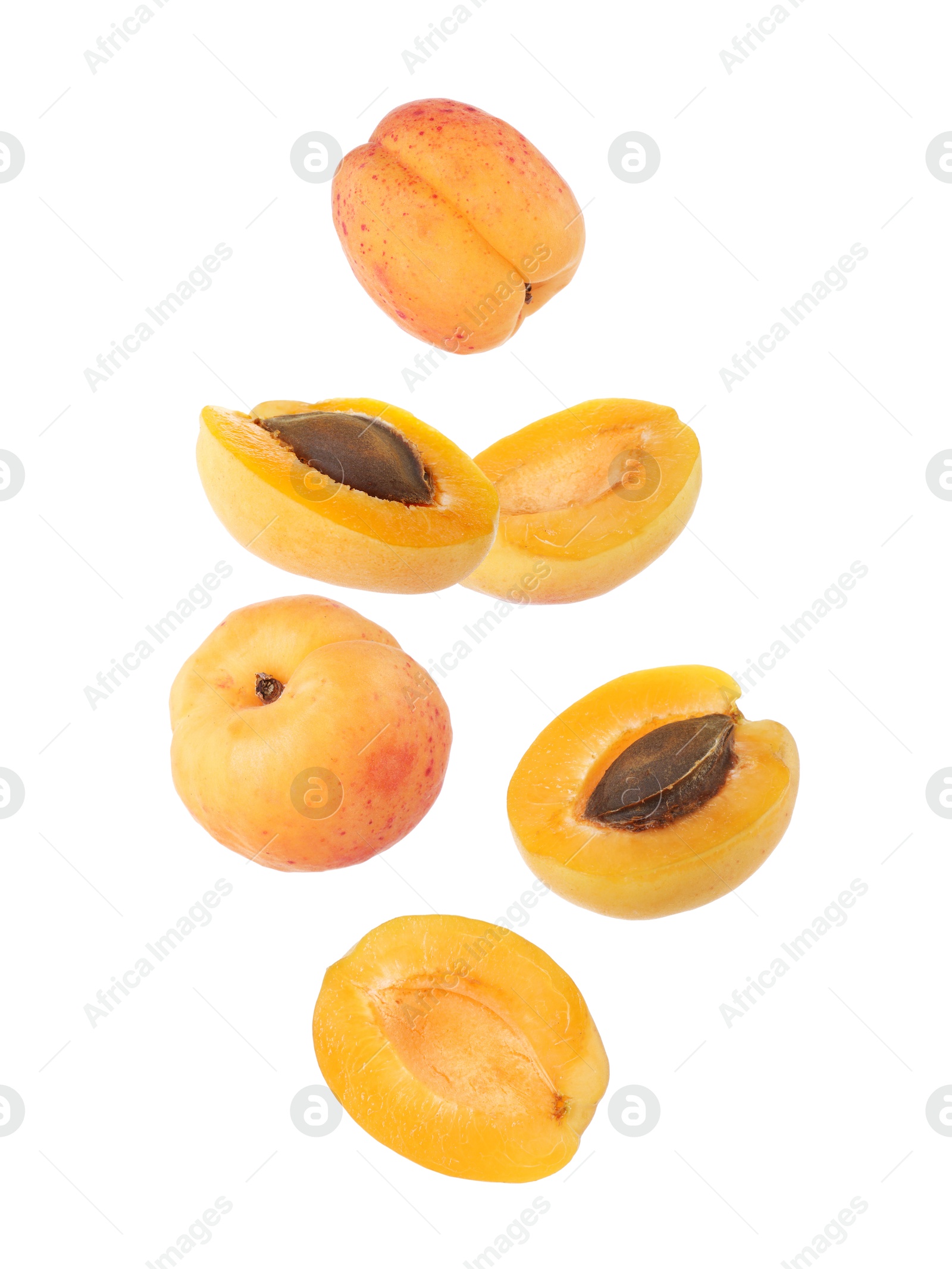 Image of Fresh juicy apricots in air against white background