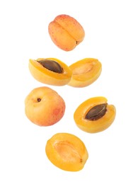 Image of Fresh juicy apricots in air against white background