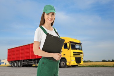 Image of Car service worker with clipboard and truck outdoors