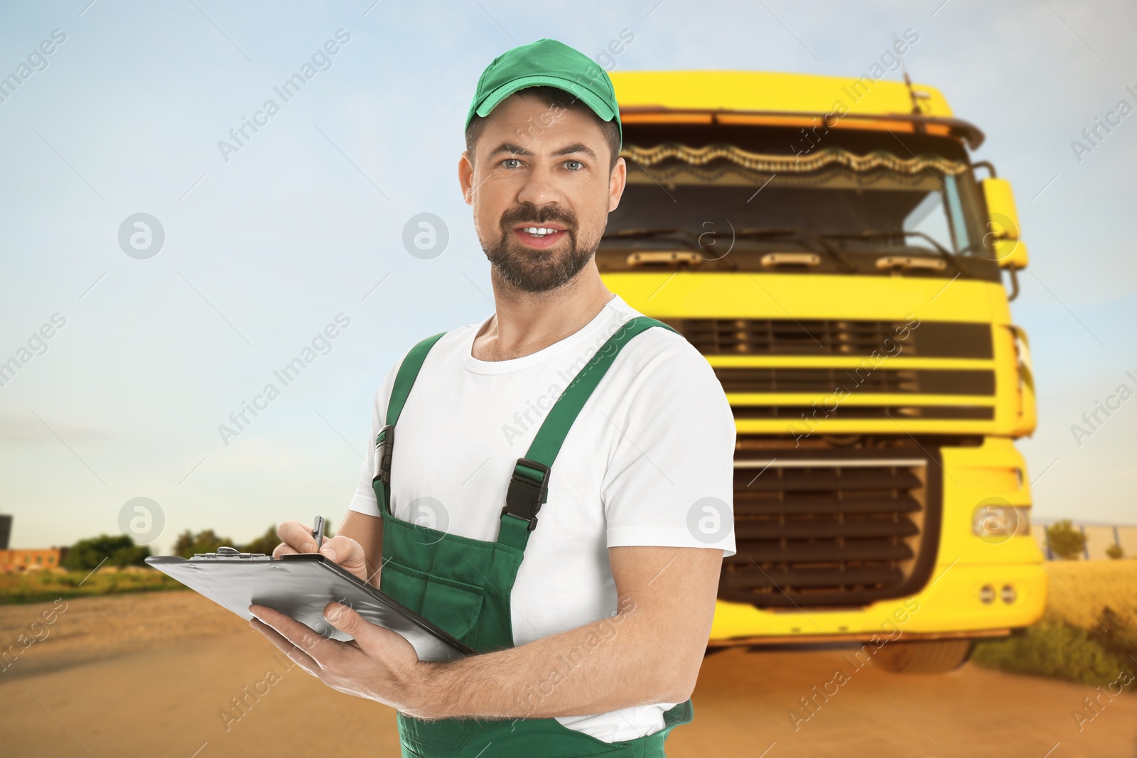 Car service worker with clipboard and truck outdoors Image of Car service worker with clipboard and truck outdoors