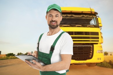Image of Car service worker with clipboard and truck outdoors