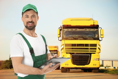 Image of Car service worker with clipboard and trucks outdoors