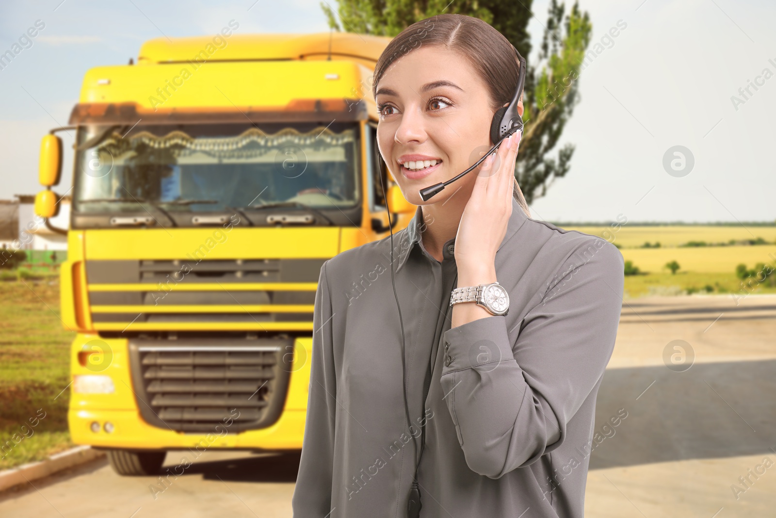 Image of Car service worker with headset against truck outdoors. Client support