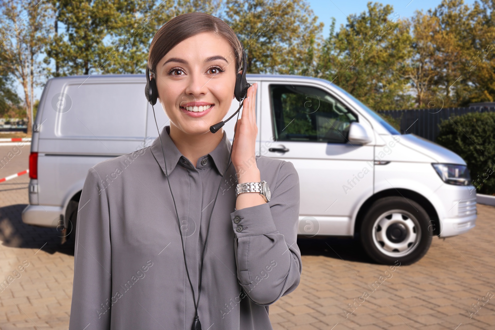 Car service worker with headset against vehicle outdoors. Client support Image of Car service worker with headset against vehicle outdoors. Client support