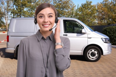 Image of Car service worker with headset against vehicle outdoors. Client support