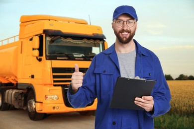 Image of Car service worker with clipboard and truck outdoors