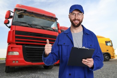 Image of Car service worker with clipboard and truck outdoors