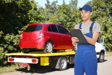 Image of Car service worker with clipboard near red auto and tow truck outdoors
