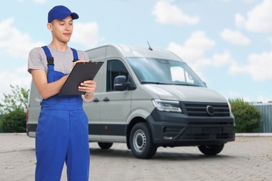 Image of Car service worker with clipboard and vehicle outdoors
