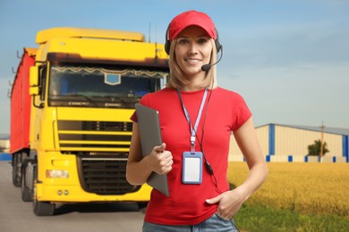 Image of Car service worker with headset and clipboard against truck outdoors. Client support