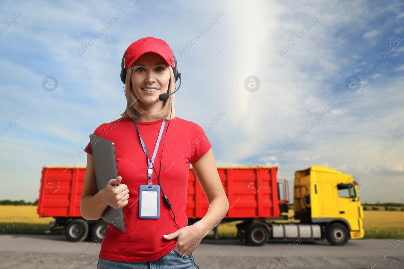 Image of Car service worker with headset and clipboard against truck outdoors. Client support