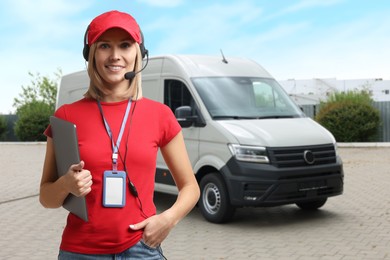 Image of Car service worker with headset and clipboard against vehicle outdoors. Client support