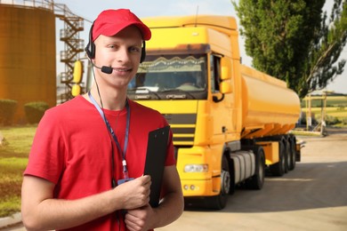 Image of Car service worker with headset and clipboard against truck outdoors. Client support