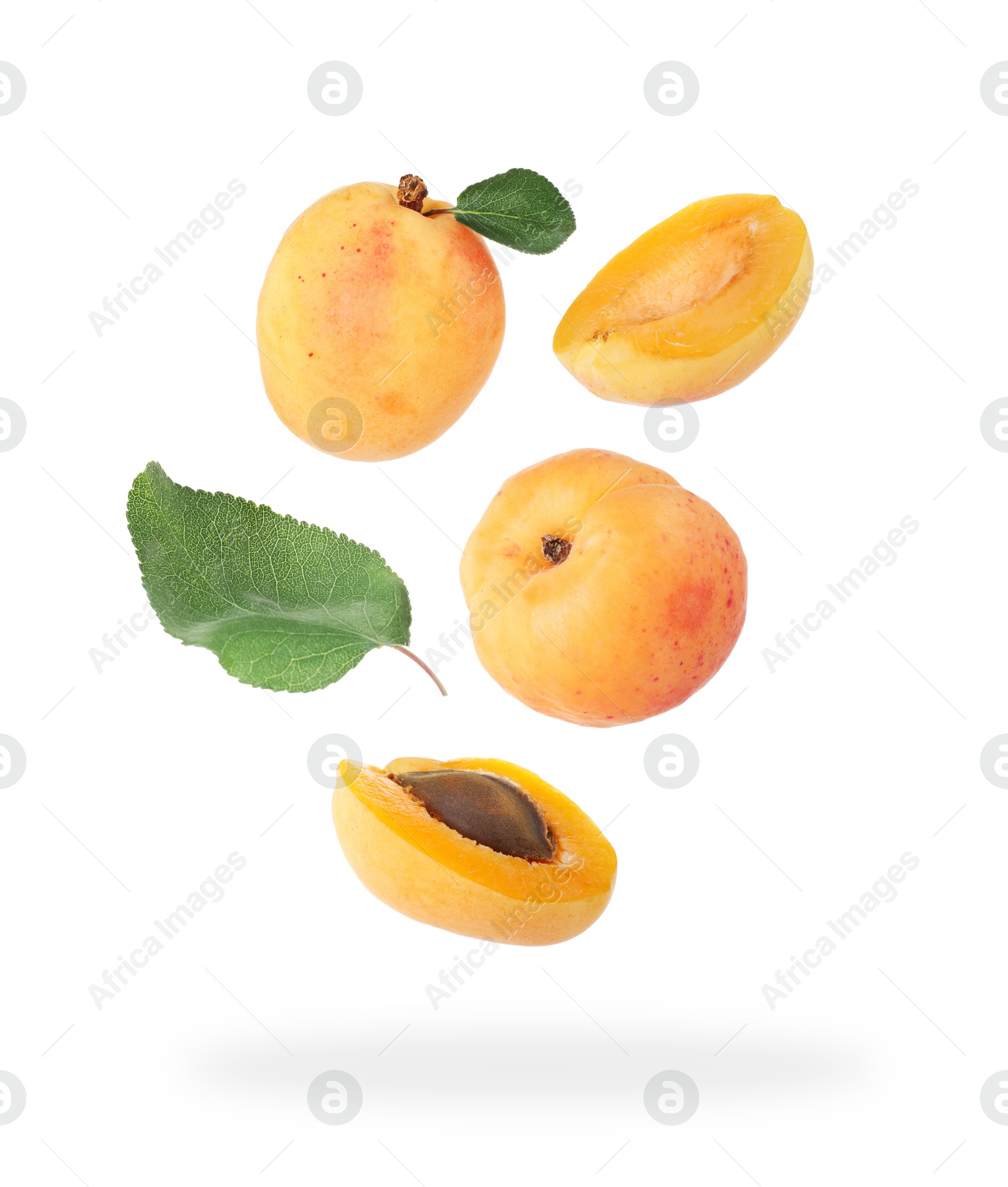 Image of Fresh juicy apricots falling against white background