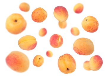 Image of Fresh juicy apricots in air against white background