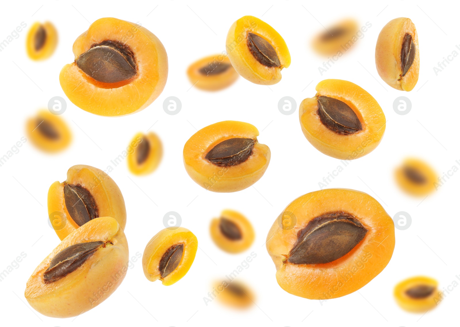 Image of Fresh juicy apricot halves in air against white background