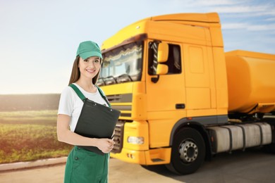 Image of Car service worker with clipboard and truck outdoors